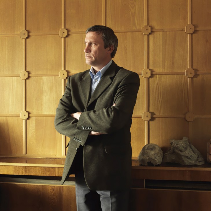 Anatoly Valuyev, deputy director of Kaliningrad's Museum of History & Arts, standing in his office with wooden paneled walls.