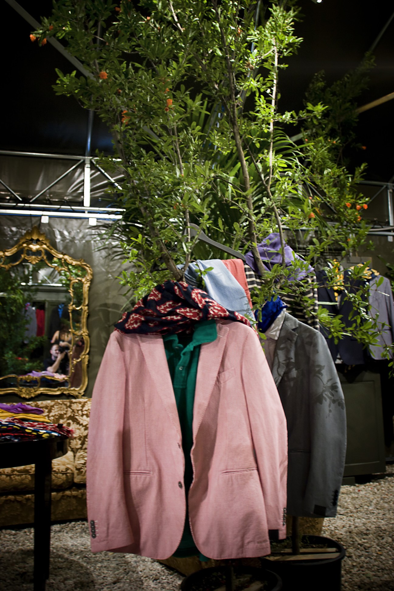 Mannequin wearing a pink blazer with colorful scarves at Piombo's Pitti Uomo stand.