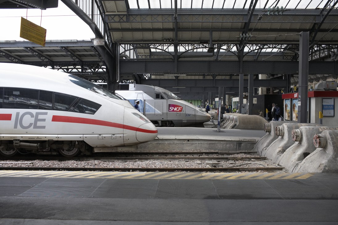 German ICE and French SNCF TGV high-speed trains parked at a station platform.