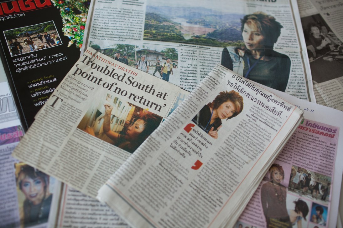 Thai newspaper pages featuring articles and photographs of forensic scientist Porntip Rojanasunan.