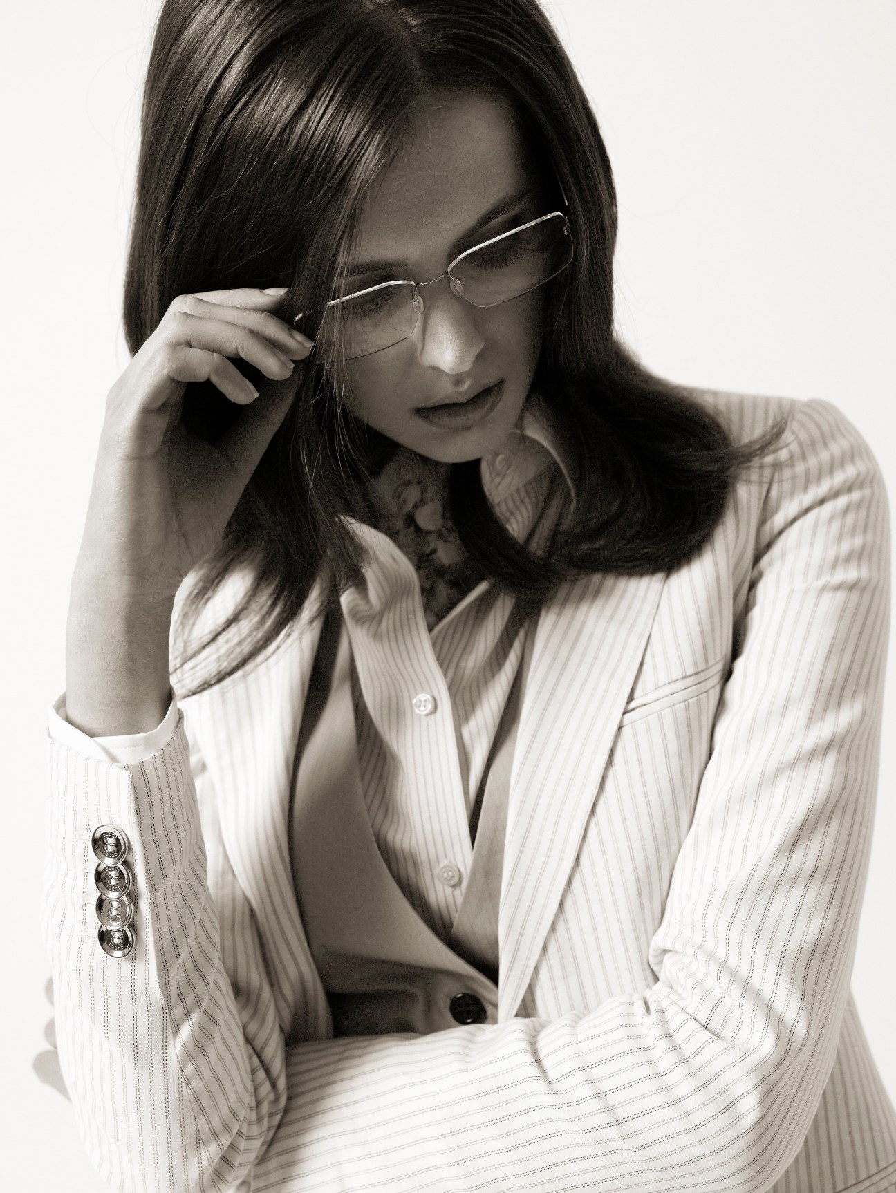 Model wearing Gucci jacket, Uniqlo waistcoat and shirt, Liberty of London scarf, and Lindberg glasses.