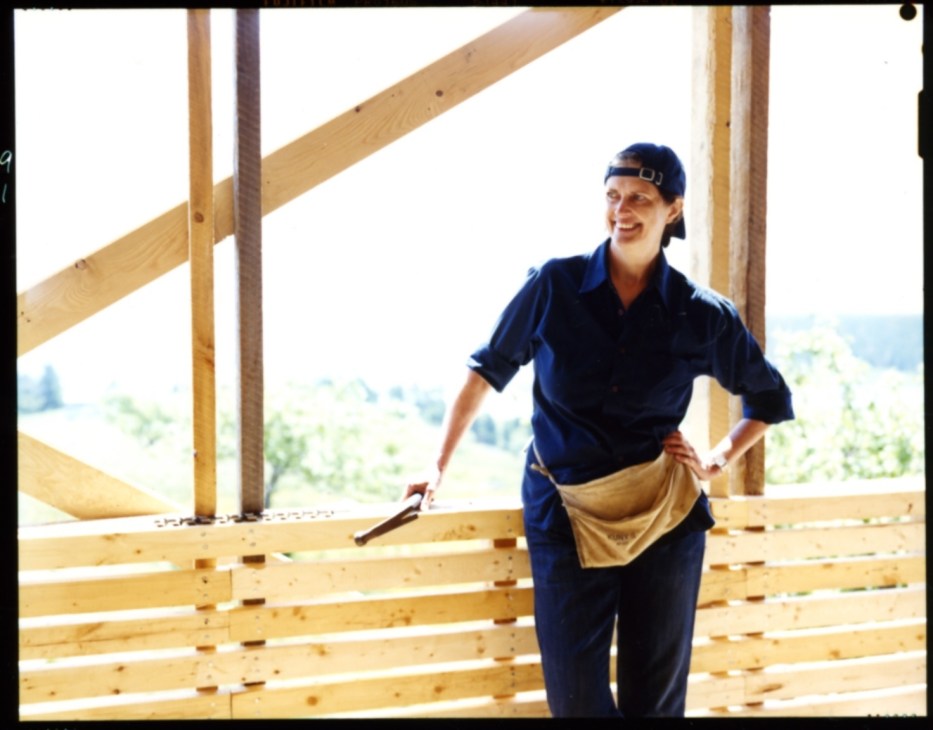 Guest architect Deborah Berke standing inside a wooden frame structure during construction at Ghost Lab.