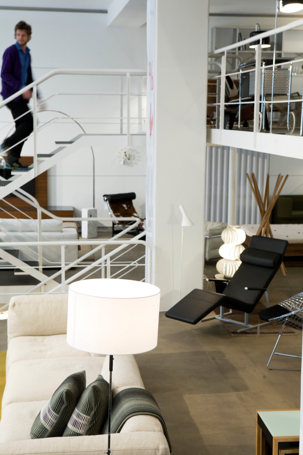Interior of Wohnbedarf furniture store in Zurich showing modern furnishings, lighting, and multi-level display space.