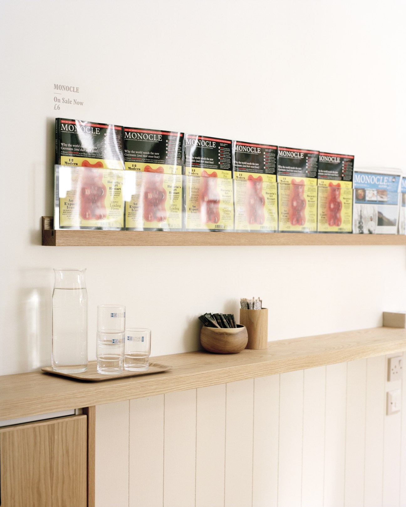 White oak display shelf with Monocle magazine back issues and café accessories.