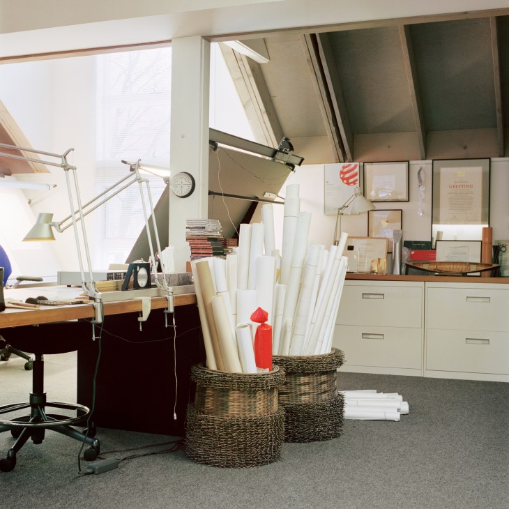 Niels Diffrient's studio workspace with rolled architectural sketches stored in wicker baskets.