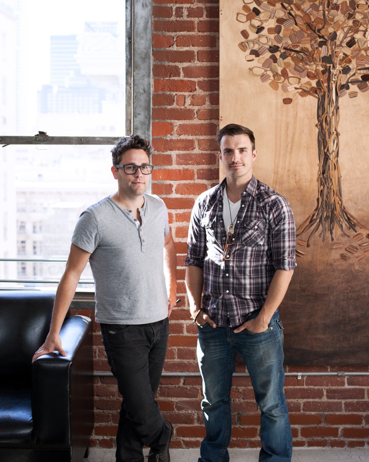 Chris Erven and CJ Thomason, co-owners of Sire's Eyewear, stand in their loft workshop.