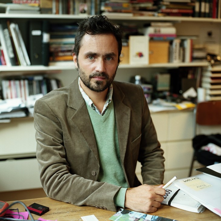 Erik Hemmendorff, director at Plattform Produktion, sitting at a desk in an office with bookshelves behind him.