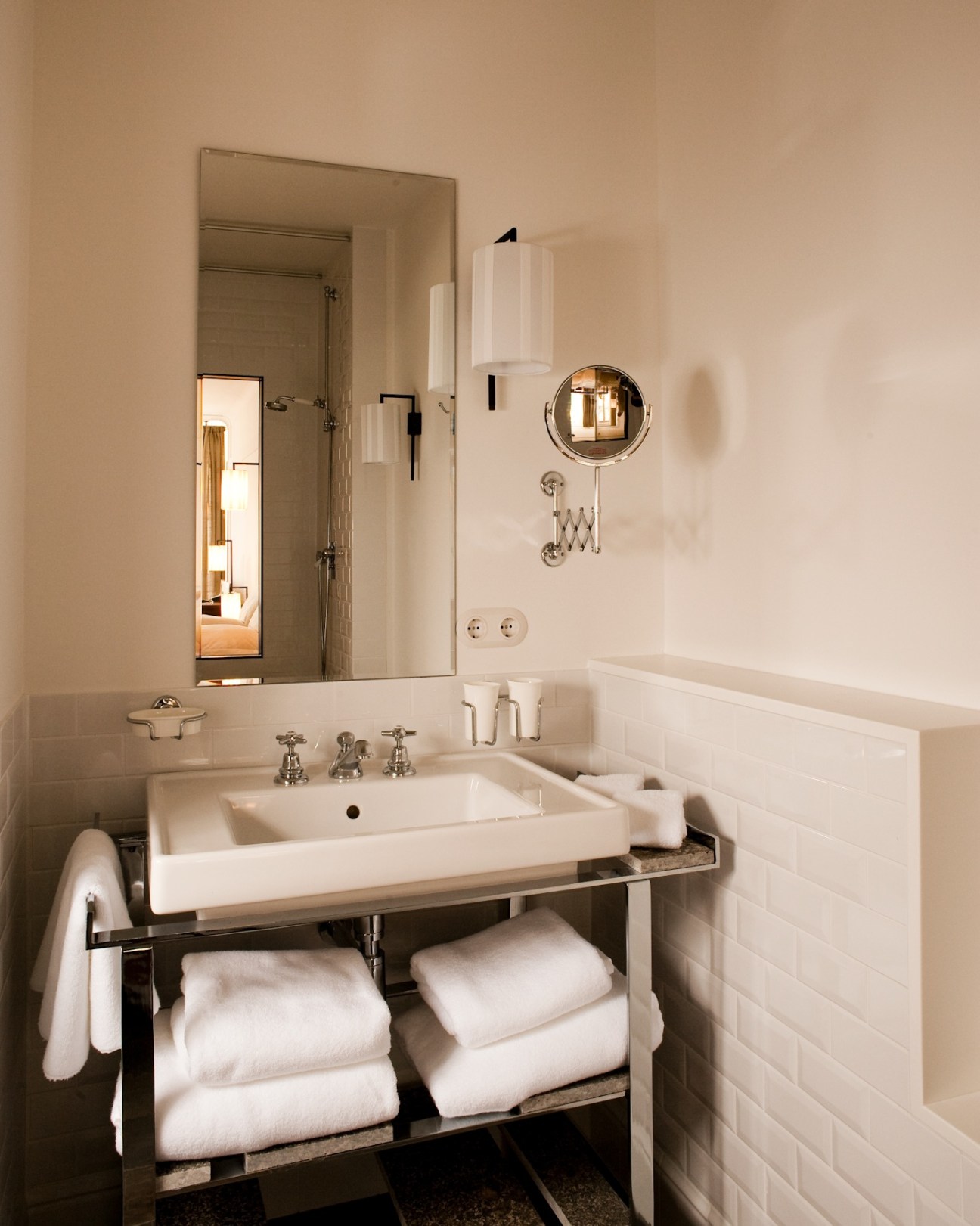 Minimalist bathroom at Louis Hotel in Munich with white sink, mirror, and modern fixtures.