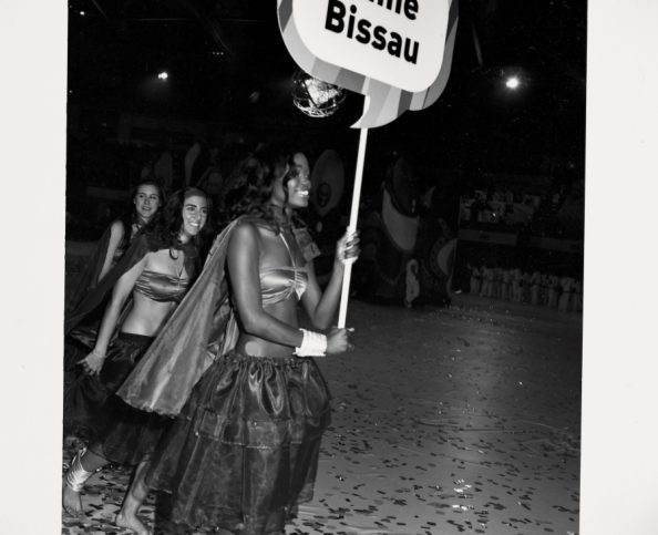 Guinea Bissau's pageant leader holds a sign at the opening ceremony of the Jogos da Lusofonia games.