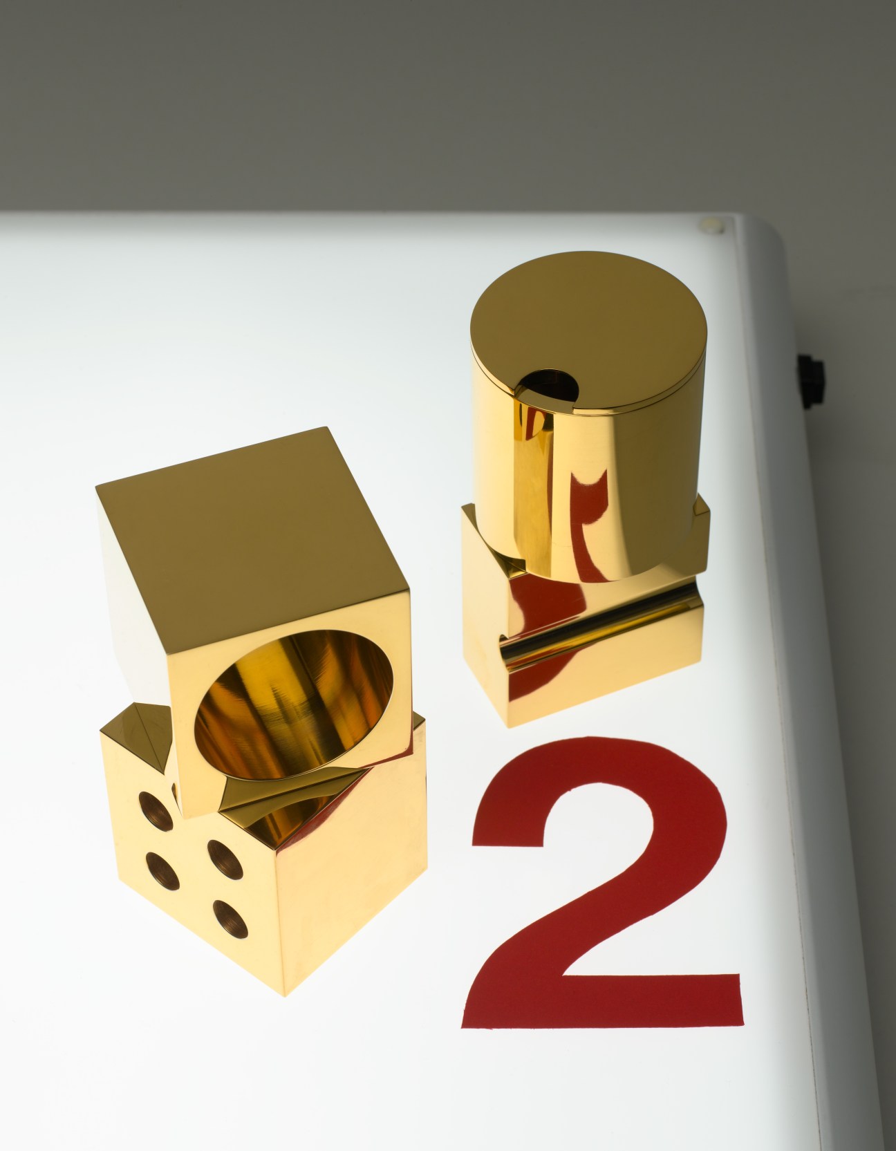 Minimalux brass pen holder and salt and pepper shaker in gold finish with cream colored bases.