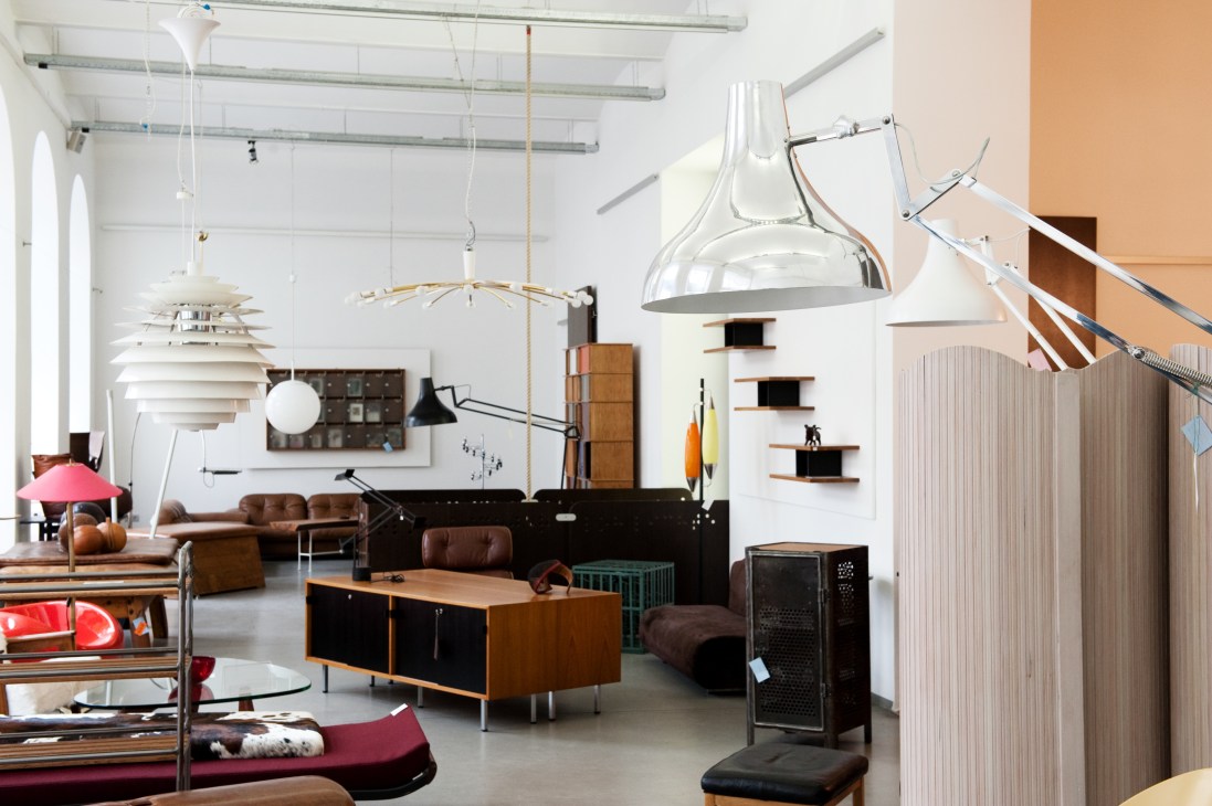 Interior of Lichterloh furniture showroom displaying mid-century modern furniture and pendant lights.