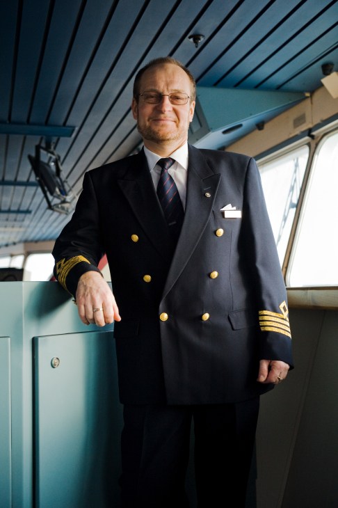 Ship captain Owe Eglund in formal naval uniform standing on the bridge of M/S Gabriella.