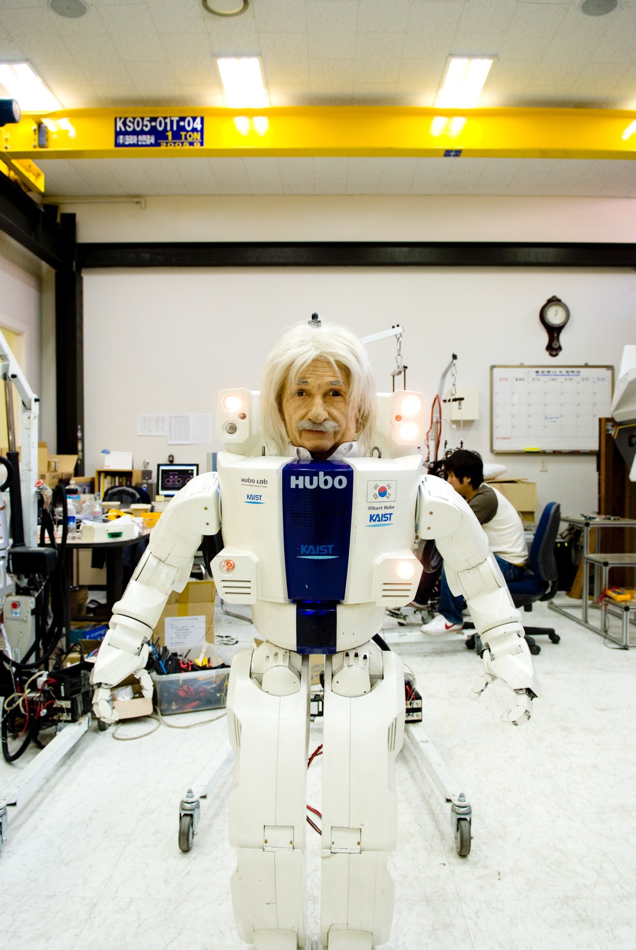 Albert Hubo humanoid robot with Einstein head in KAIST laboratory, wearing white body and blue chest panel.