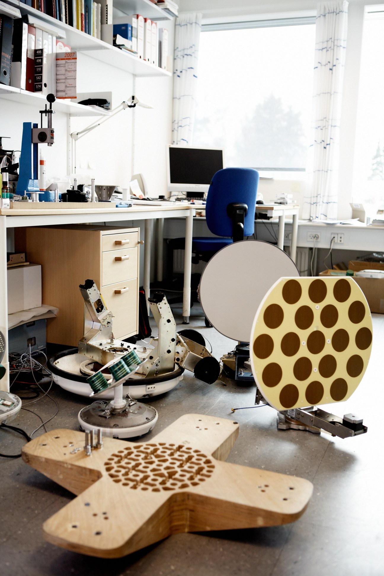 Testing office with Sailor 500 antenna components and satellite communication equipment.
