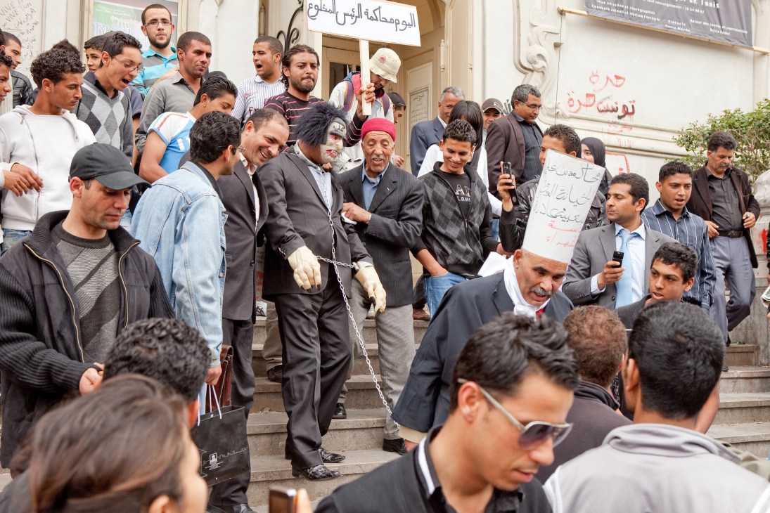 Protesters stage a mock trial of former president Zine El Abidine Ben Ali on courthouse steps in Tunis.