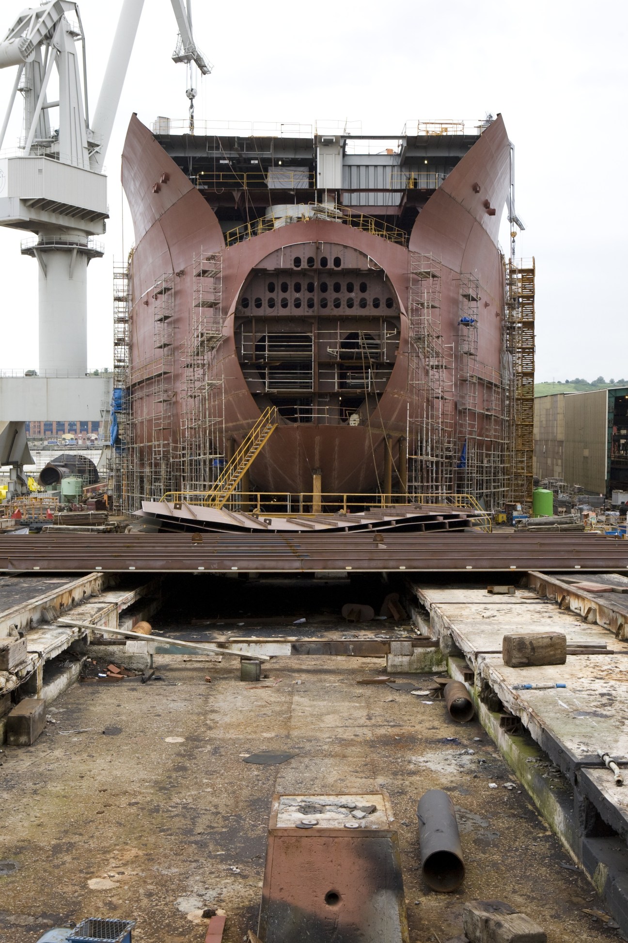 Ship under construction on slipway at La Naval shipyard with large gantry crane overhead.