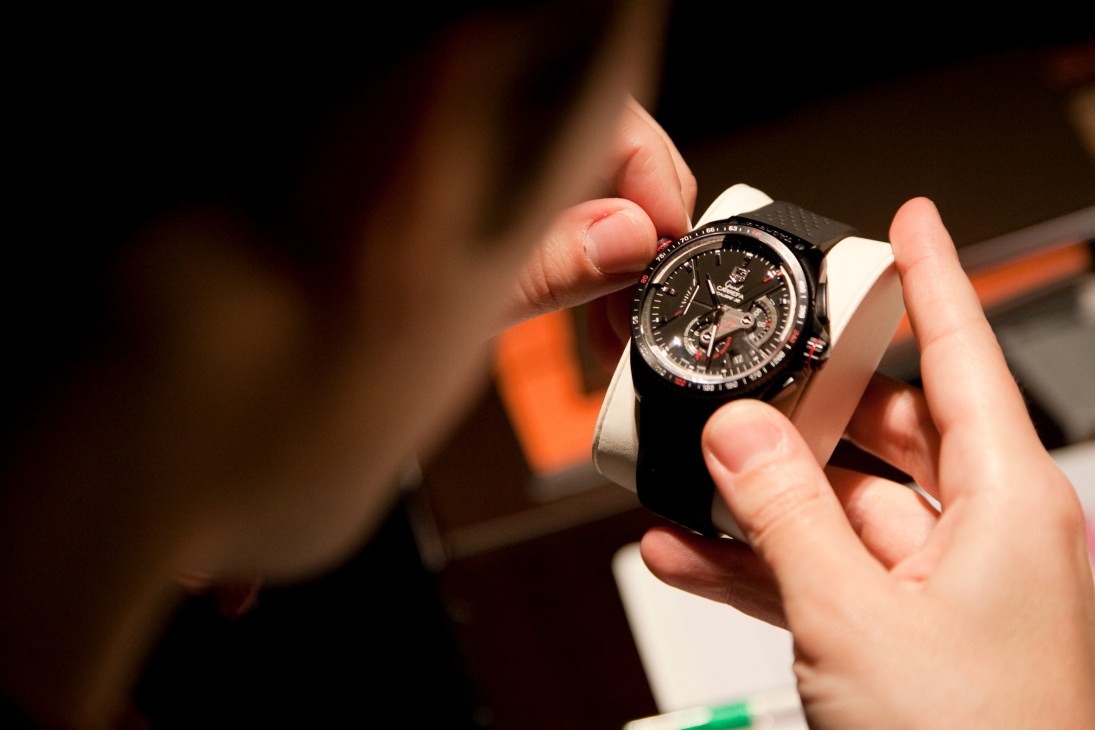 TAG Heuer's Grand Carrera, Calibre 36 watch held in hands against blurred background.