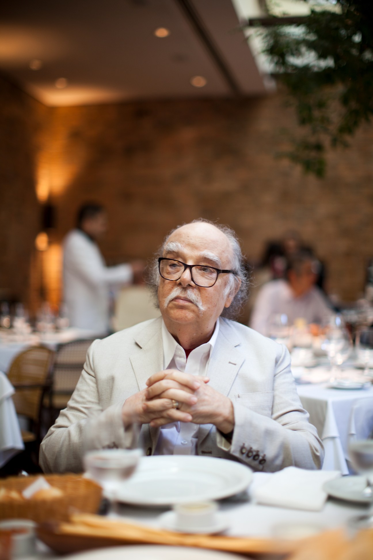 Sergio Rodrigues contemplates his last meal at a dining table in Gero restaurant.