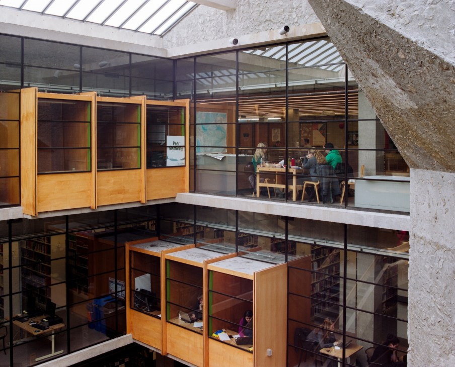 Bata Library interior showing wooden storage units and glass partitions across multiple levels with skylights above.
