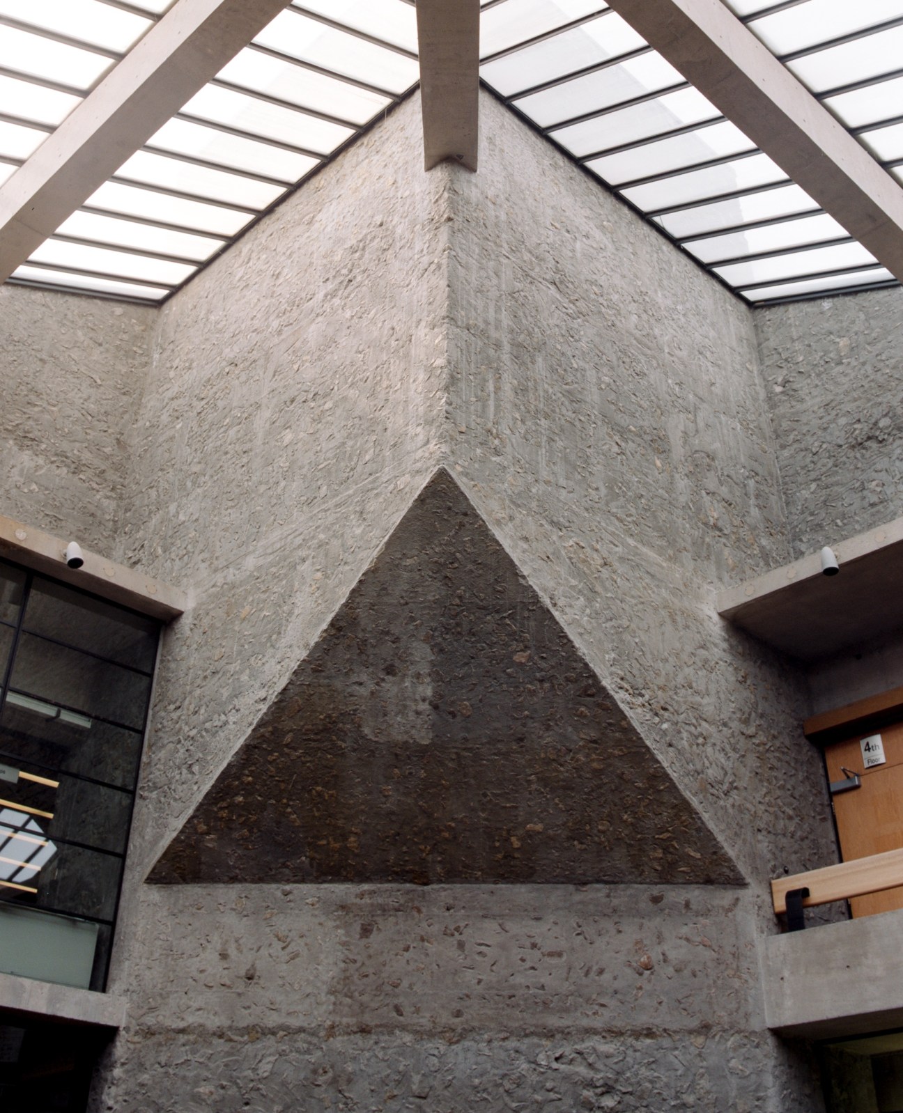 Concrete linear architectural detail of Bata Library showing textured aggregate walls and skylights.