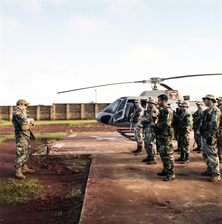 Senad special forces personnel in camouflage uniforms stand near a Helibras helicopter at their base in Pedro Juan Caballero, Paraguay.