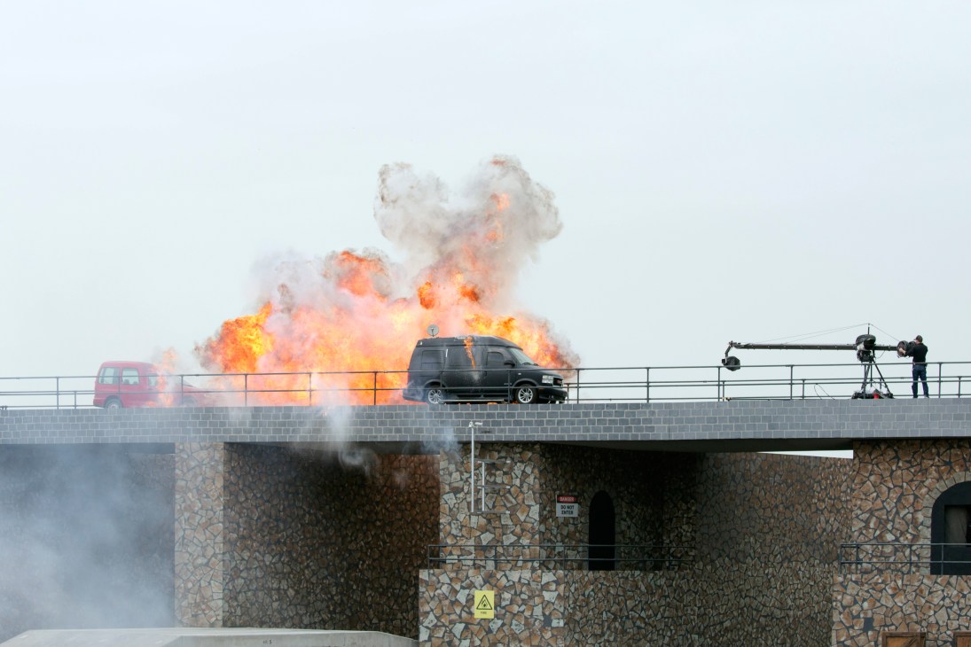 Vehicles explode in flames on a bridge during a mock terrorist attack demonstration at the Idex opening ceremony.