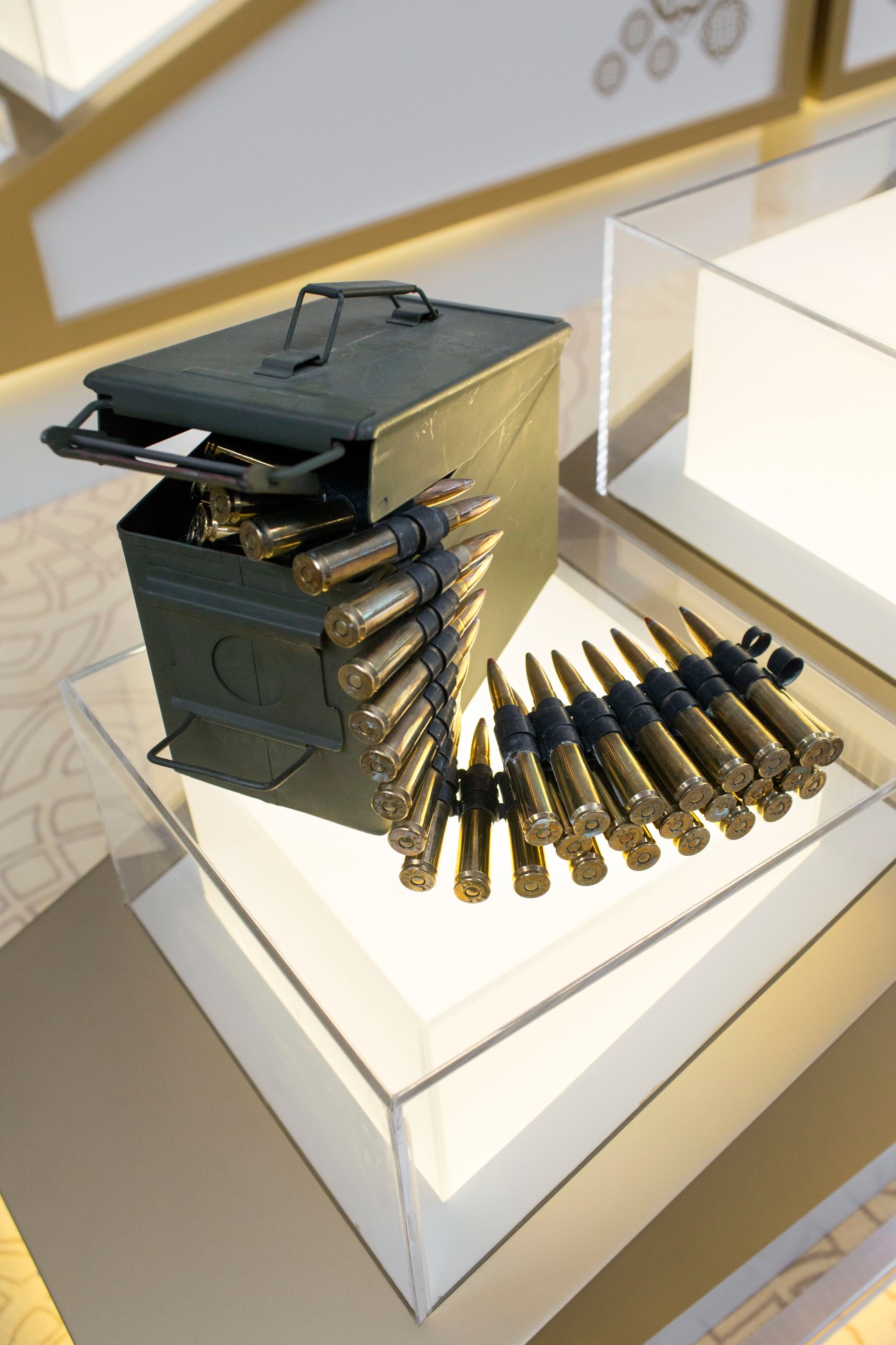 Ammunition for the .50 machine gun displayed in an ammunition can with linked rounds at the International Golden Group stand.
