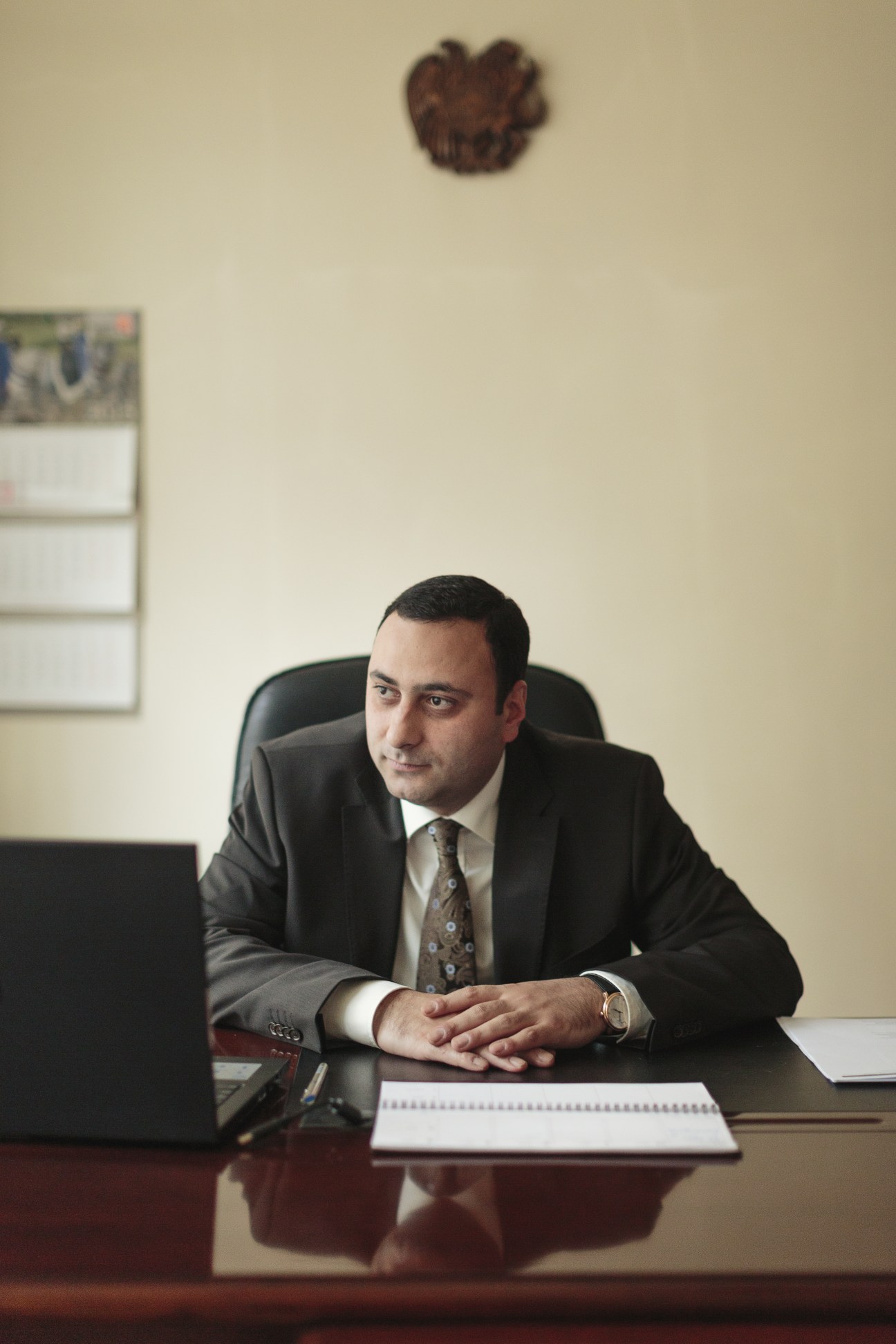 Gegham Petrosyan, executive director of the National Center for SME Development, sits at his desk in a Soviet-era office.
