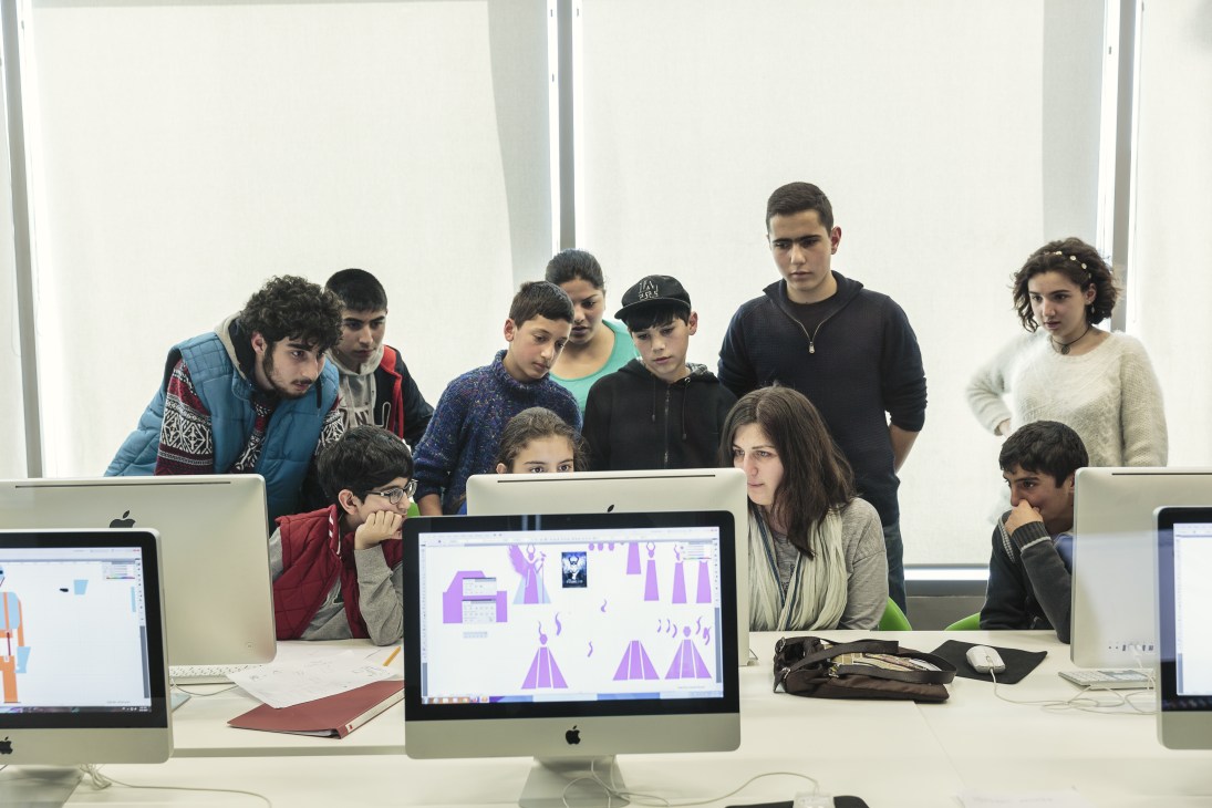 Young people work at Apple computers during a graphic design workshop at the Tumo Center for Creative Technologies in Yerevan.