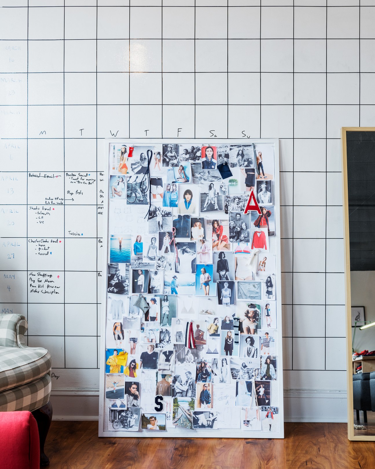 Design moodboard with photographs and inspirational images pinned to white wall grid