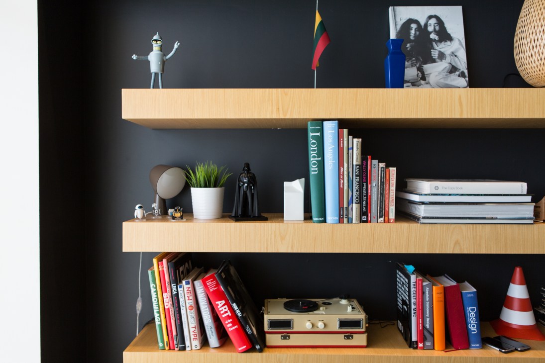 Wooden shelving with books, design objects, and a vintage turntable in Pixelmator's office.
