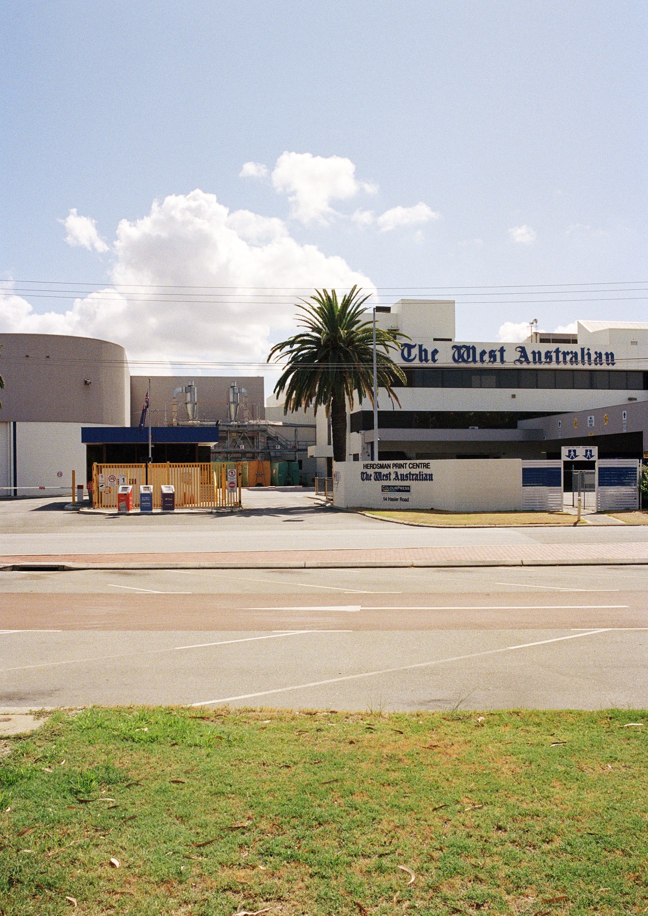 The West Australian newspaper headquarters building in Perth's Osborne Park with Herdsman Print Centre signage visible.