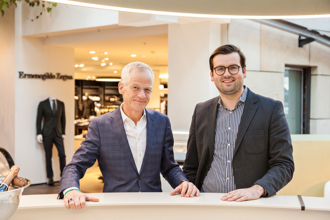 Andreas Hilgenstock and Simon Engelhorn stand at a counter inside Engelhorn department store.