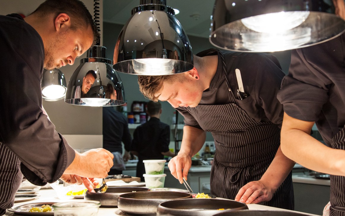 Chefs prepare dishes in the kitchen of Opus V, Engelhorn's Michelin-starred restaurant.