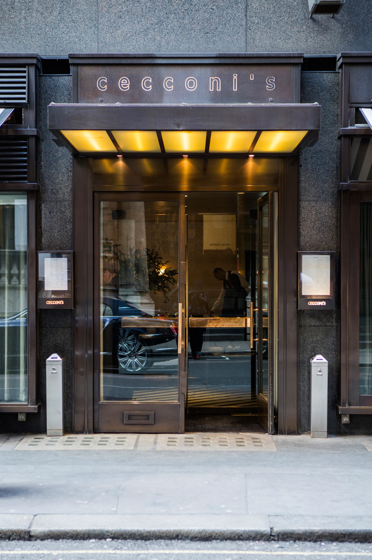 Cecconi's restaurant entrance on Burlington Gardens with illuminated signage and dark storefront.