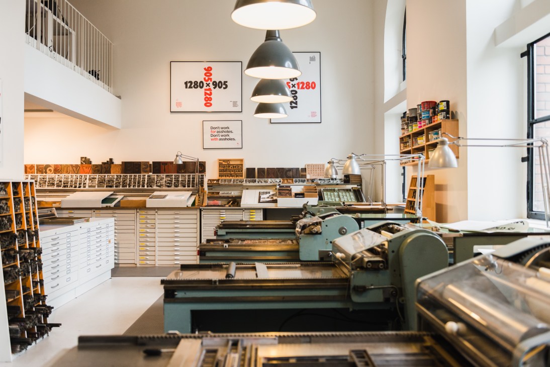 Printing presses and metal typographic materials in P98A studio's workspace.