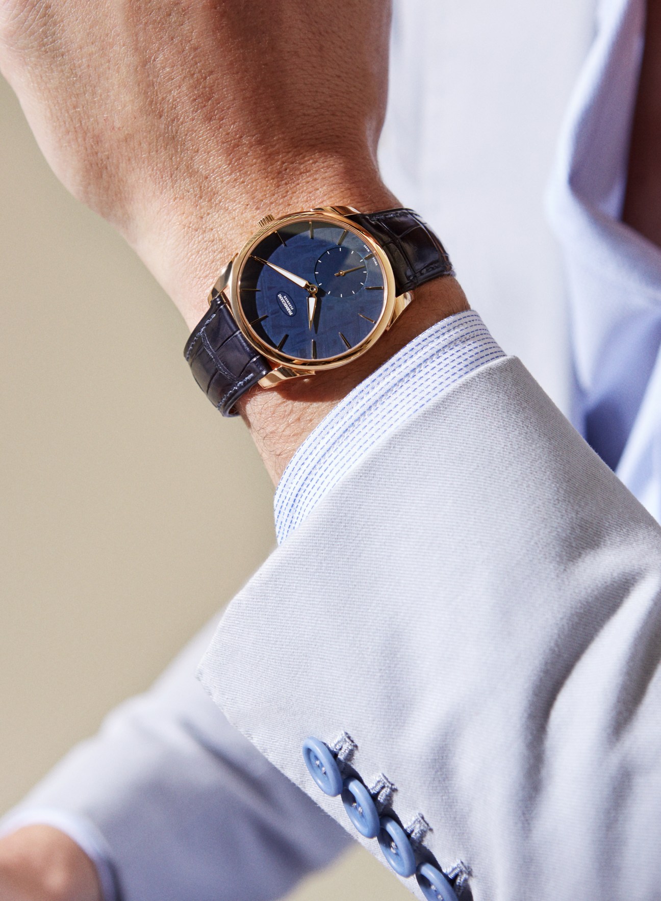 Parmigiani Fleurier Tonda 1950 meteorite watch with rose gold case and blue dial worn on wrist.