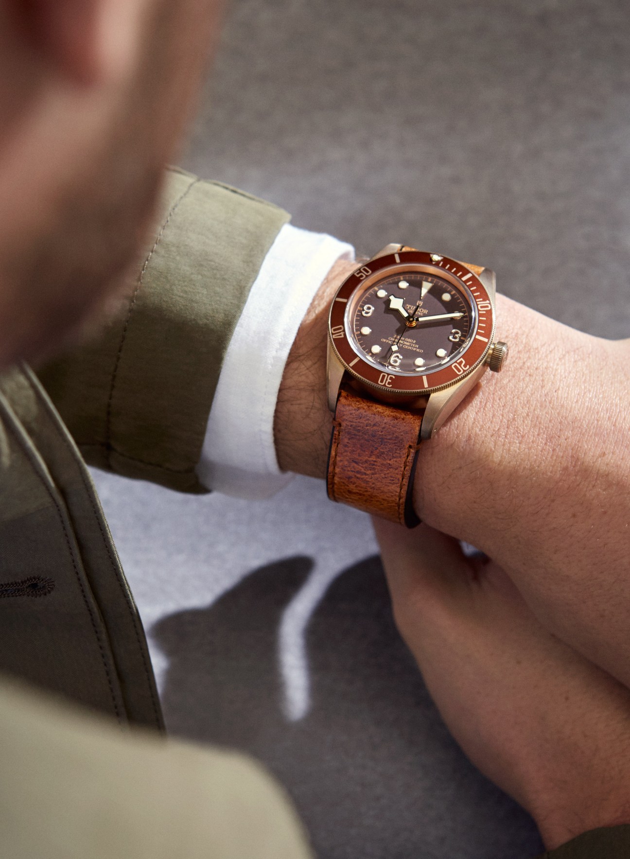 Heritage Black Bay Bronze watch by Tudor worn on wrist with brown leather strap