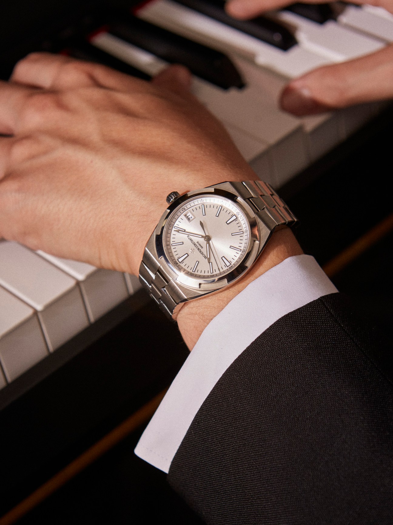 Vacheron Constantin Overseas self-winding watch on man's wrist with white shirt cuff