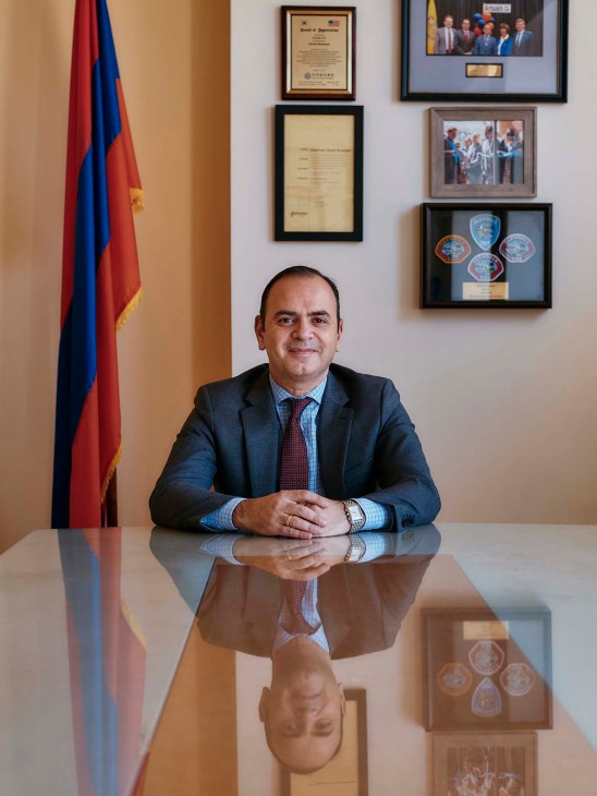 Zareh Sinanyan, Armenia's High Commissioner for Diaspora Affairs, sits at a desk with the Armenian flag behind him.