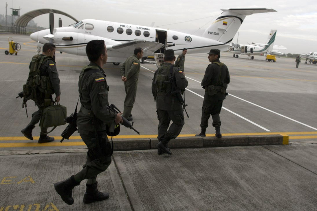 Colombian anti-narcotics police officers boarding a Policia Nacional aircraft at Bogotá airport.