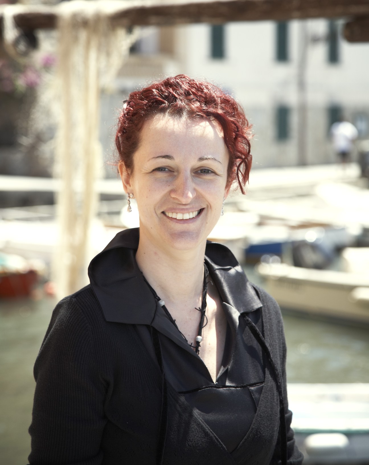 Eleonora Bozzi, owner of Locanda Tre Merli, smiling at the Camogli harbour.