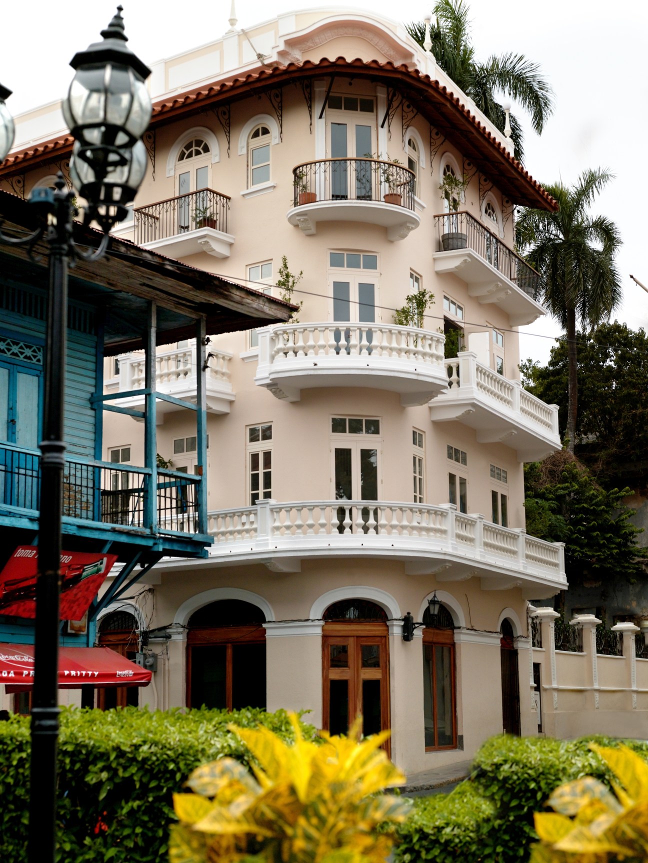 Exterior of Las Clementinas, a cream-coloured colonial building with red-tiled roof and curved balconies in Panama City's Casco Viejo.