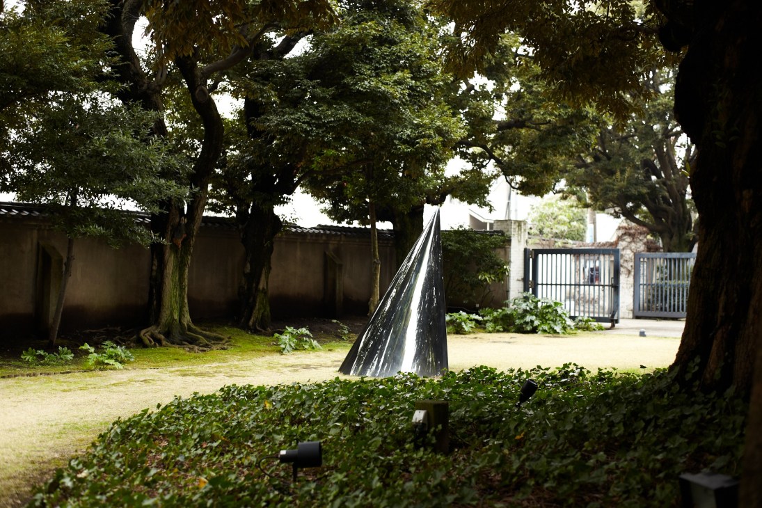 Outdoor sculpture installation in a garden setting with mature trees and manicured hedges at Hara Museum of Contemporary Art, Tokyo.