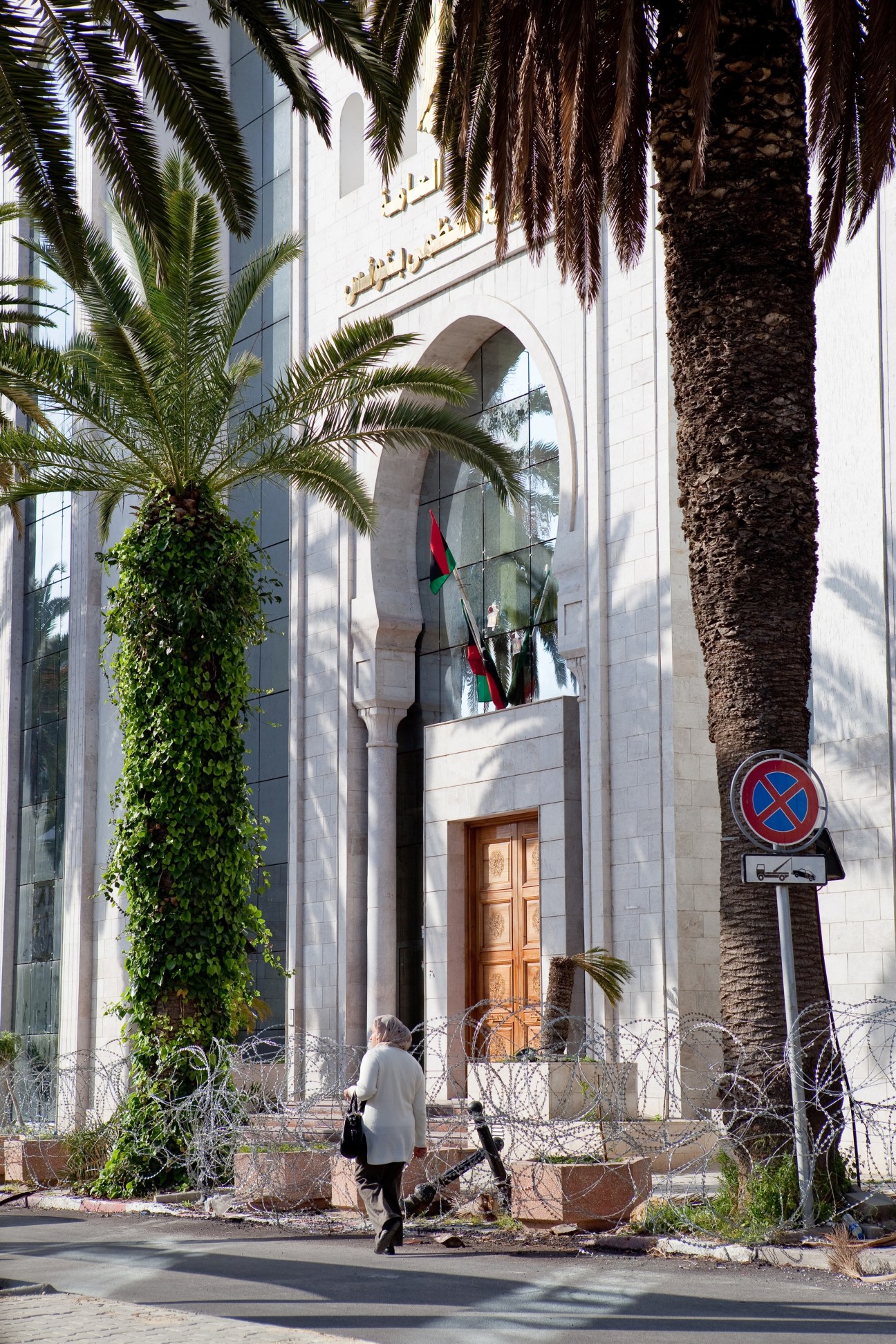 Libya's embassy in Tunis, surrounded by barbed wire and palm trees.