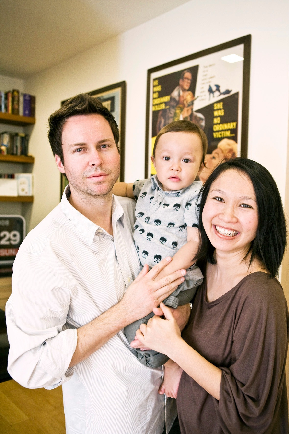 Bryan Ott and Panita Phongthananan with their young child in their Ari home.