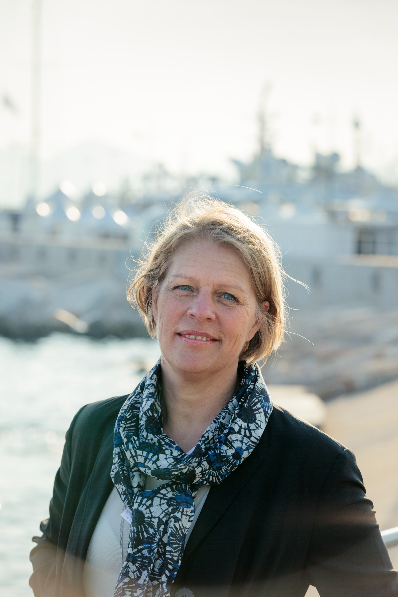 Monica von Schmalensee, CEO of White Arkitekter, Stockholm, posing outdoors with Cannes waterfront buildings in background