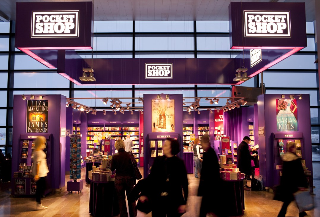 Thalia Pocket Shop storefront with purple and pink signage displaying books and traveller merchandise.