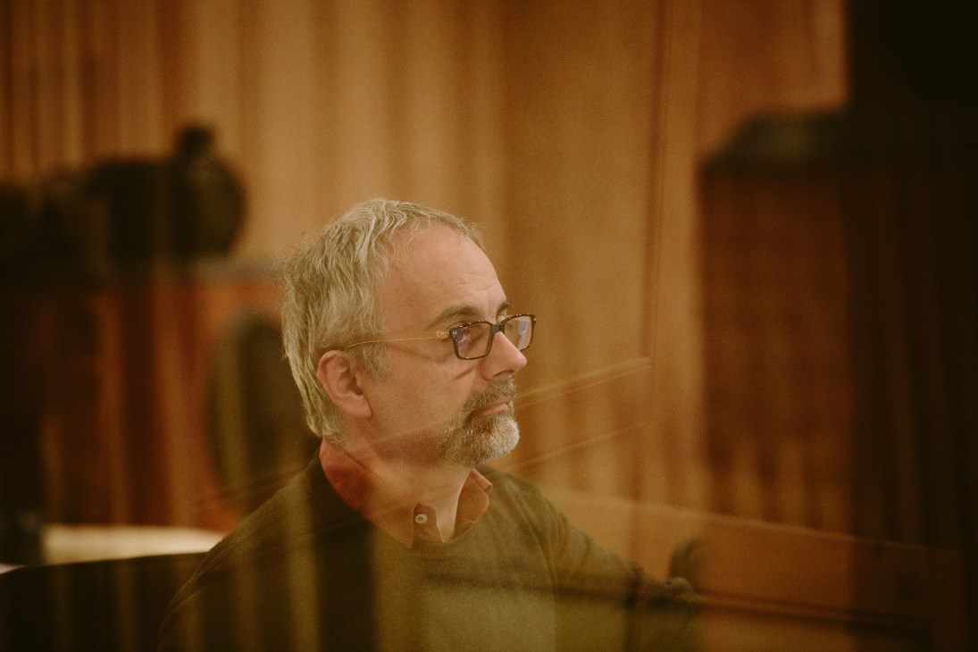 Sound engineer in profile at a studio control console