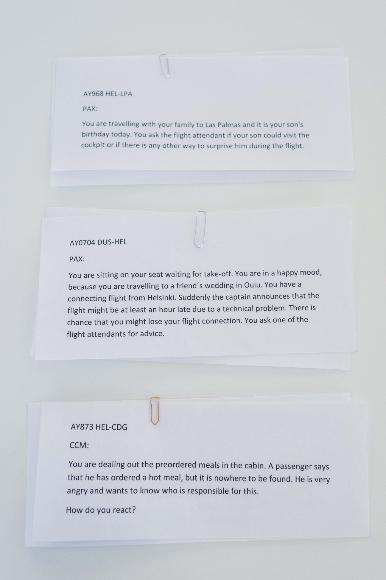 Flight scenario cards describing passenger situations for Finnair flight attendant training exercises.